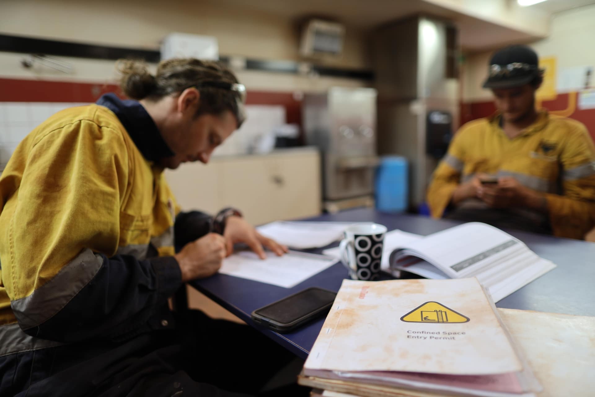 Construction workers working with papers and documents on table