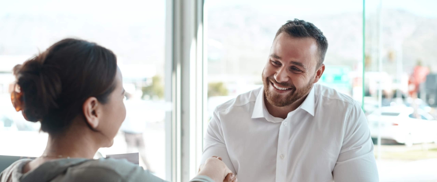 Man and woman meeting and shaking hands