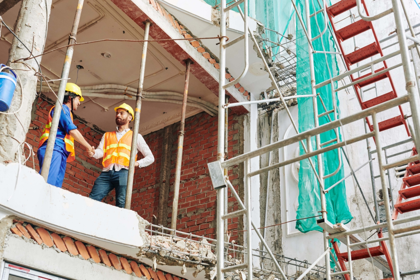construction workers on site wearing protective hats and jackets